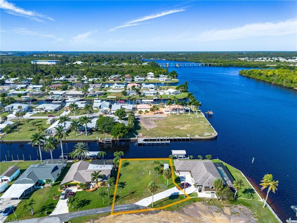Image 1: Aerial overview of property's location featuring a nearby body of water