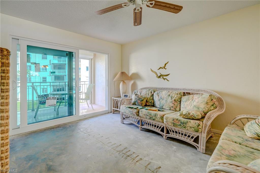 Image 4: Sitting room featuring a textured ceiling, a ceiling fan, and unfinished concrete floors