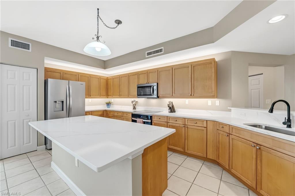Image 1: The sellers have recently elevated the kitchen with newly installed quartz countertops and a beautifully redesigned island&mdash;perfect for gathering with guests while the chef prepares meals. Enhanced with under- and over-cabinet lighting, brand-new stainless steel appliances, and a fresh, refined repaint throughout, the space exudes a bright, modern sophistication, creating a truly inviting and refreshed culinary environment.