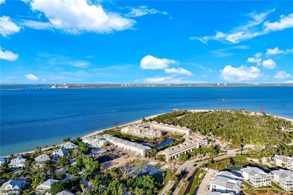 Image 1: Aerial view of residential area featuring a large body of water
