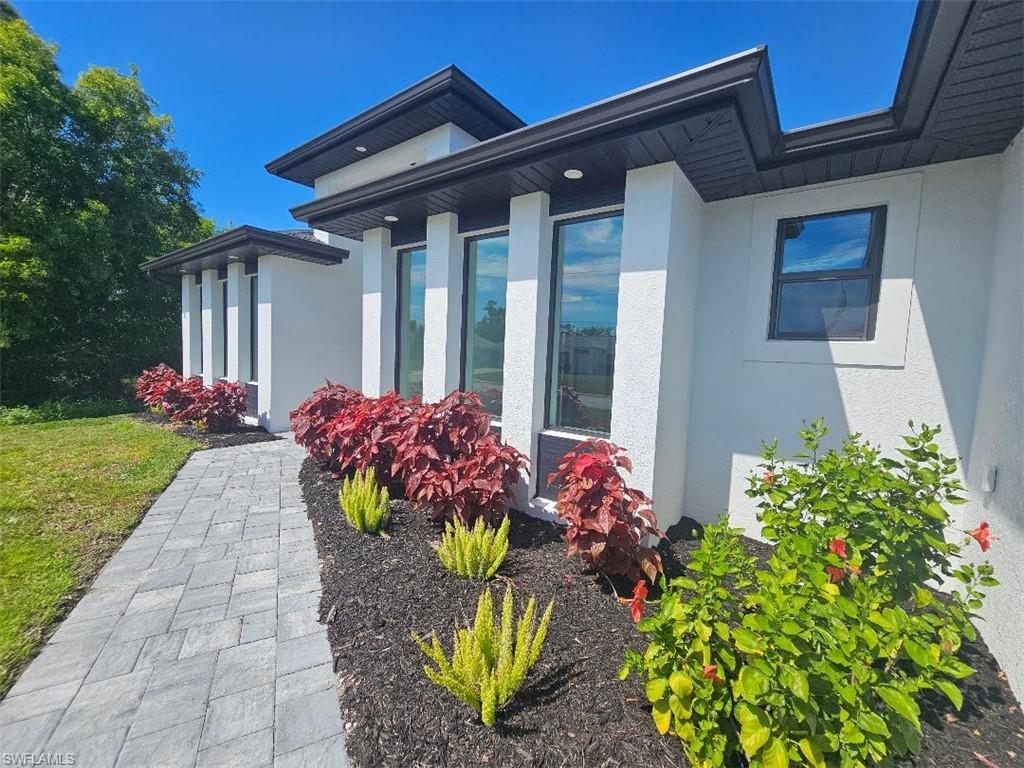 Image 2: View of property exterior with stucco siding