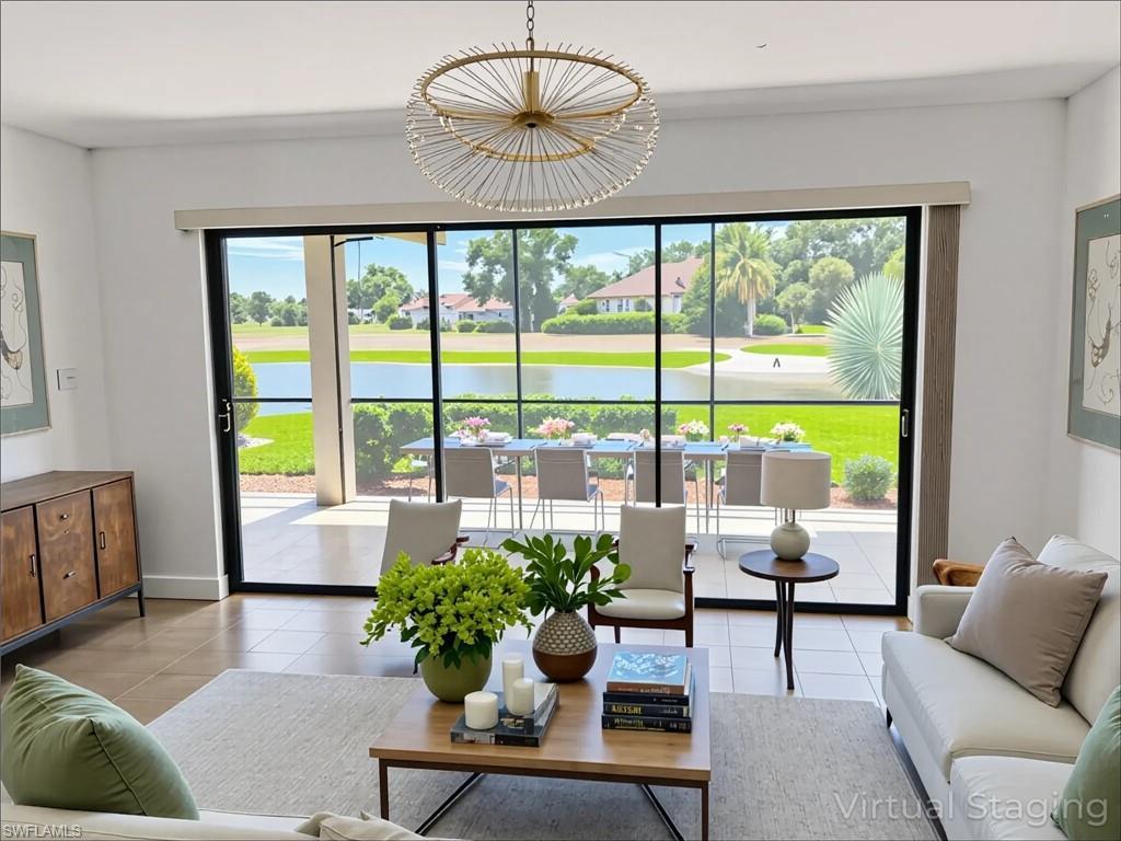 Image 2: Living area with tile patterned floors, plenty of natural light, and a water view