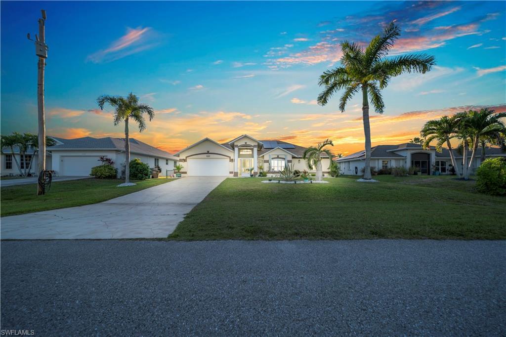 Image 1: Ranch-style house featuring driveway, a lawn, and a residential view
