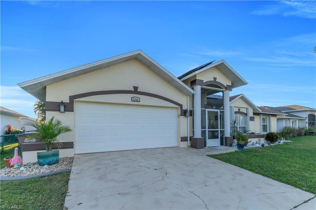 Image 3: Single story home with a front yard, driveway, stucco siding, an attached garage, and a sunroom