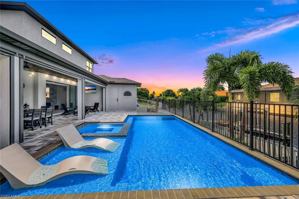 Image 3: View of swimming pool with a patio and a pool with connected hot tub