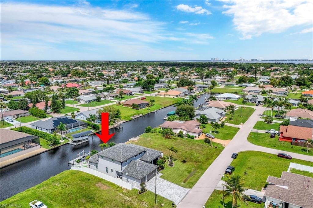 Image 4: Aerial view of residential area with a large body of water