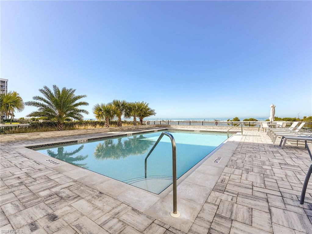 Image 3: Community pool with a patio