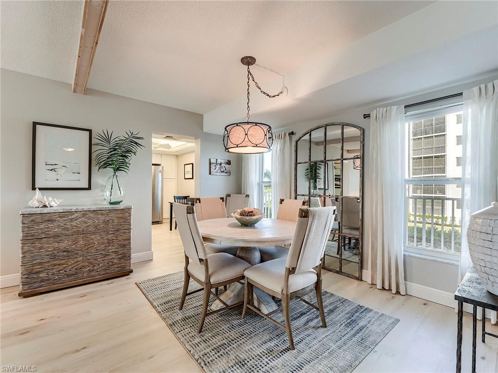 Image 4: Dining area featuring light wood finished floors and beam ceiling