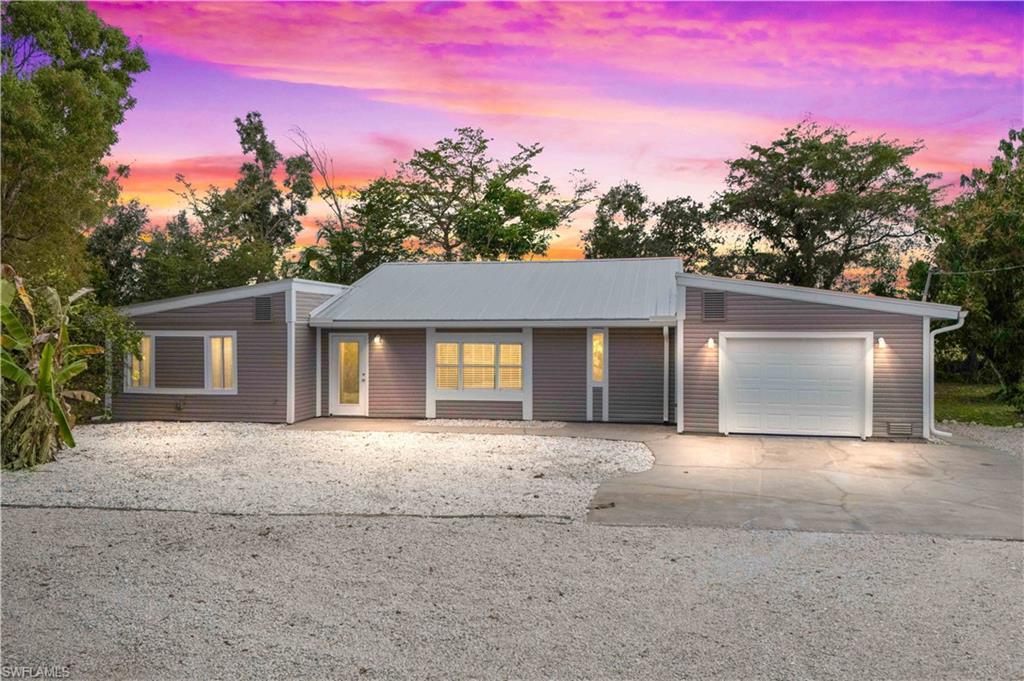 Image 1: Welcome home to your private Pine Island retreat&mdash;nestled on over an acre of lush, peaceful land with a gated front yard and serene island surroundings.