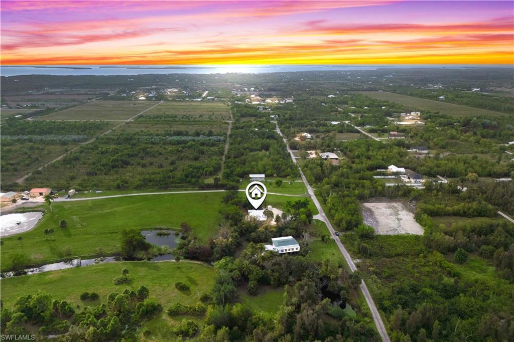 Image 2: Sunset skies highlight the privacy and beauty of this secluded Pine Island property.