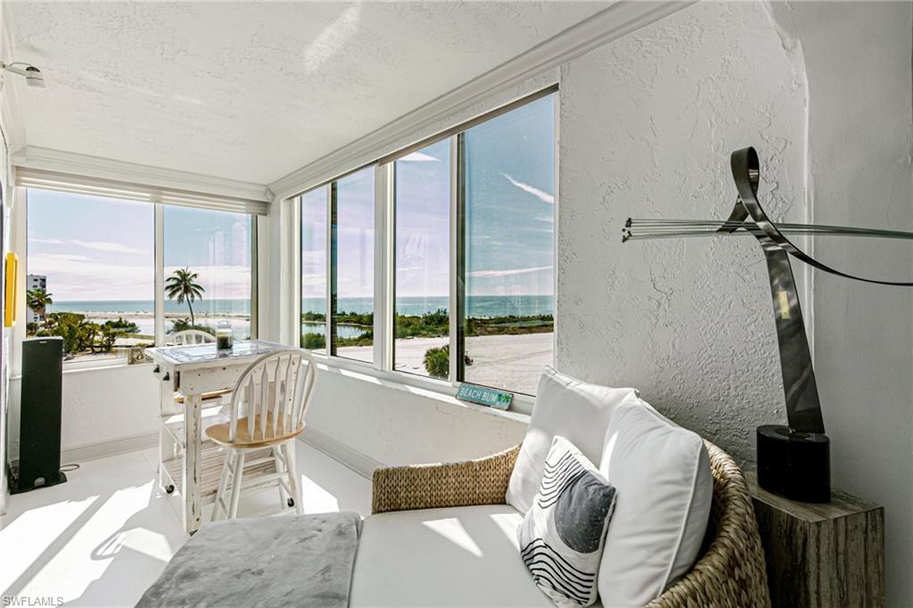 Image 4: Sunroom with a textured wall and a water view