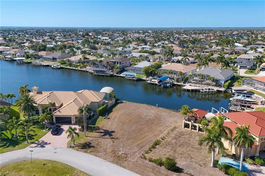 Image 2: Aerial perspective of suburban area with a large body of water