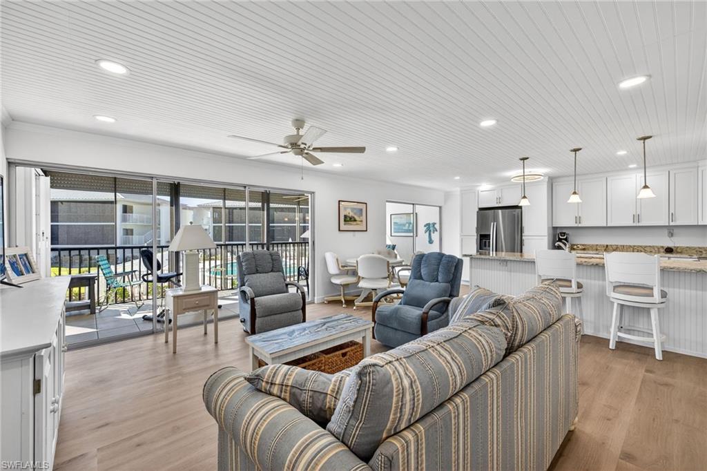 Image 3: Great room featuring ceiling fan, recessed lighting, light wood-style flooring, and wooden ceiling