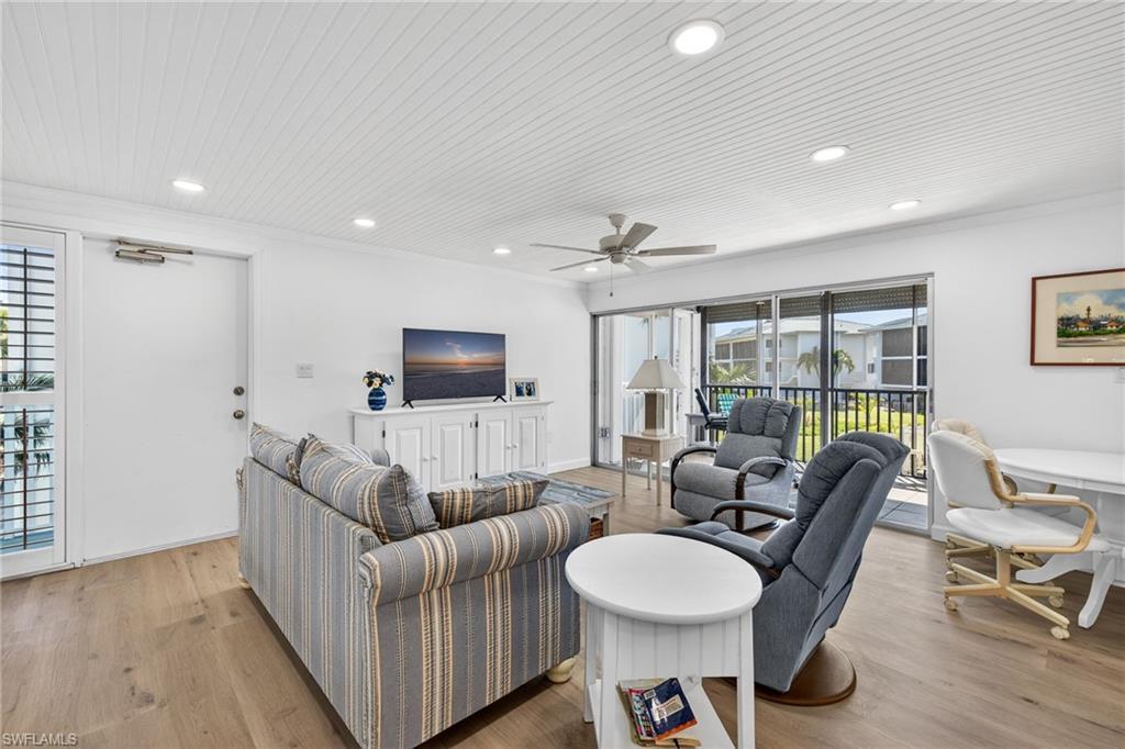 Image 4: Living room featuring light wood-style flooring, a ceiling fan, wooden ceiling, recessed lighting, and crown molding