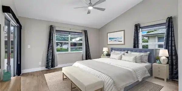 Image 4: Virtually Staged Primary Bedroom with Sliding Door to Pool