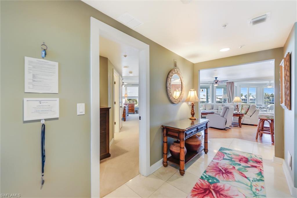 Image 3: Hallway featuring light tile patterned floors and light colored carpet