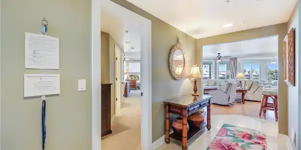 Image 3: Hallway featuring light tile patterned floors and light colored carpet