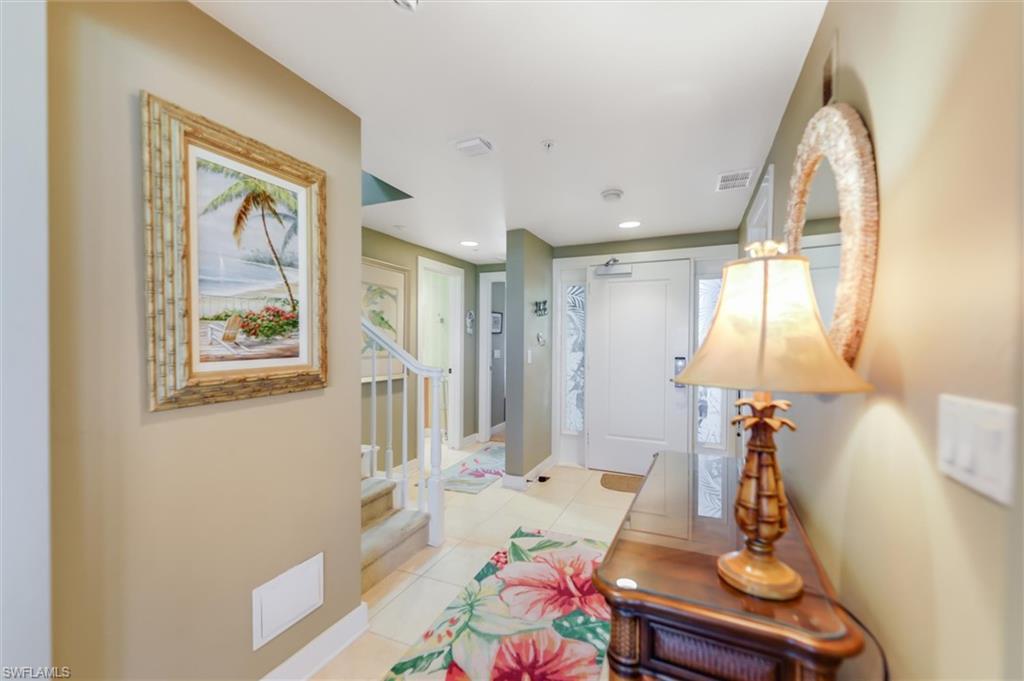 Image 4: Hallway with light tile patterned flooring and recessed lighting