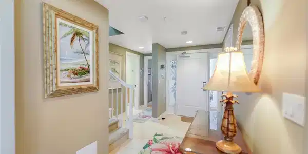 Image 4: Hallway with light tile patterned flooring and recessed lighting