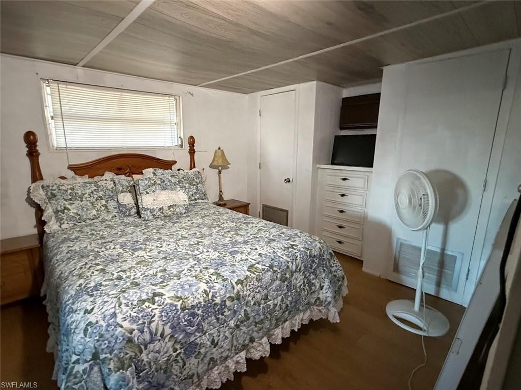 Image 3: Bedroom featuring wood finished floors, a closet, and wood ceiling