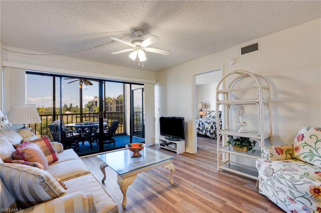 Image 1: Living area with a ceiling fan, wood finished floors, and a textured ceiling