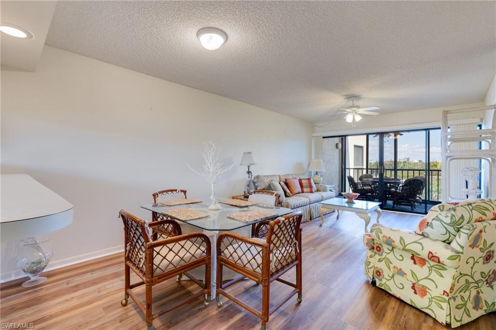 Image 4: Dining space with light wood-type flooring, a textured ceiling, and a ceiling fan