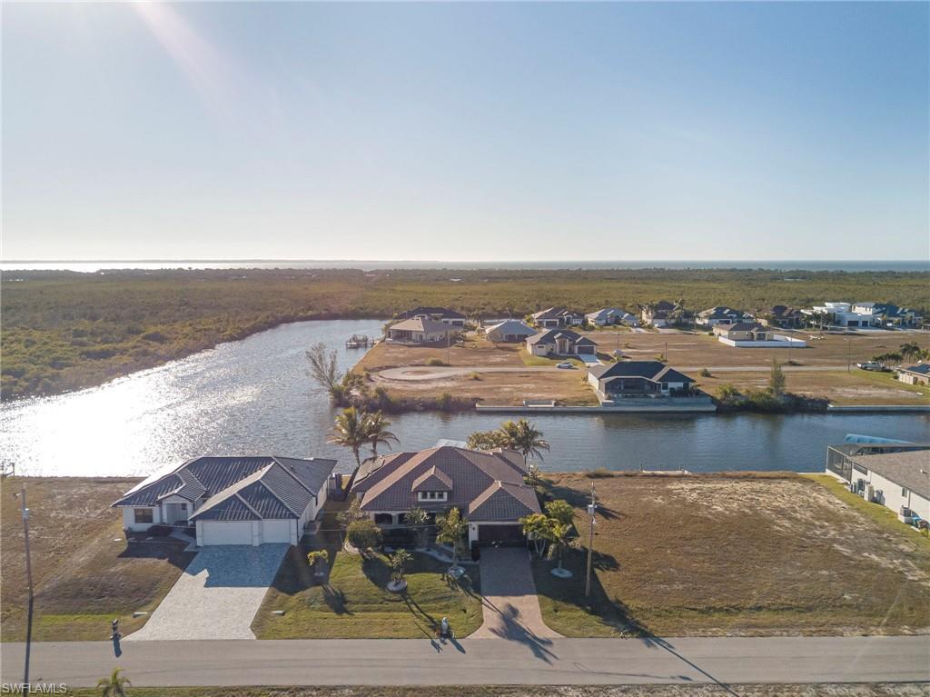 Image 1: Aerial view of residential area with a large body of water