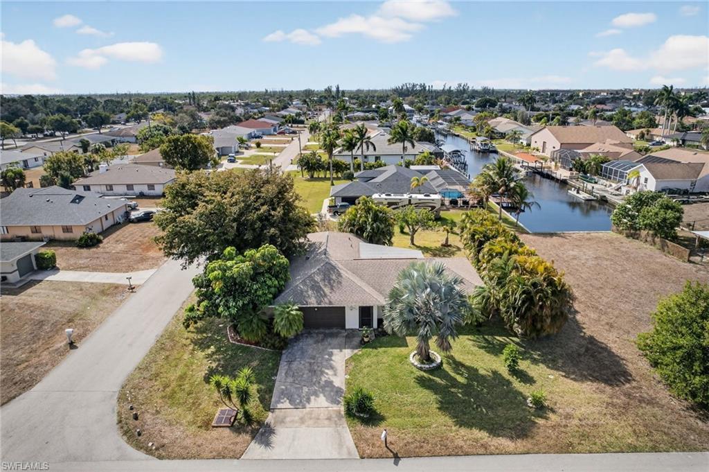 Image 1: Aerial perspective of suburban area with a large body of water