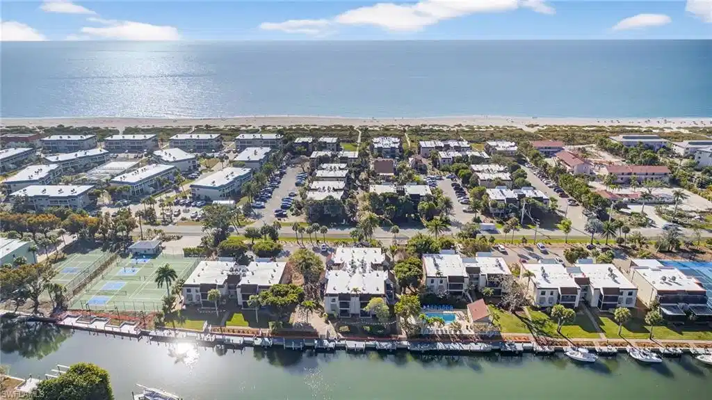 Image 1: Aerial perspective of suburban area with a nearby body of water