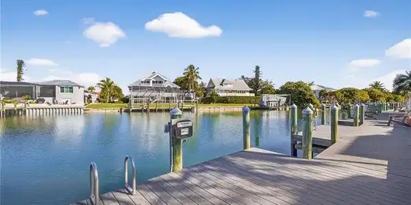 Image 2: Dock featuring a water view and a residential view