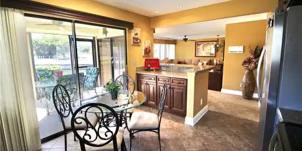 Image 3: Large eat in kitchen overlooking screened in lanai