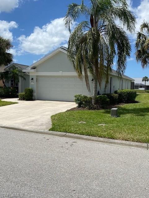 Image 2: Ranch-style house with a garage, concrete driveway, a front yard, and stucco siding