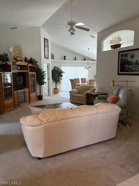 Image 3: Living area with plenty of natural light, ceiling fan, light carpet, and a high ceiling