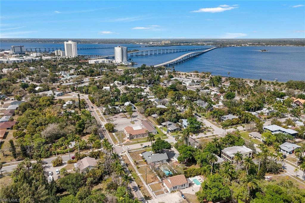 Image 2: Aerial view of residential area with a notable bridge and a large body of water