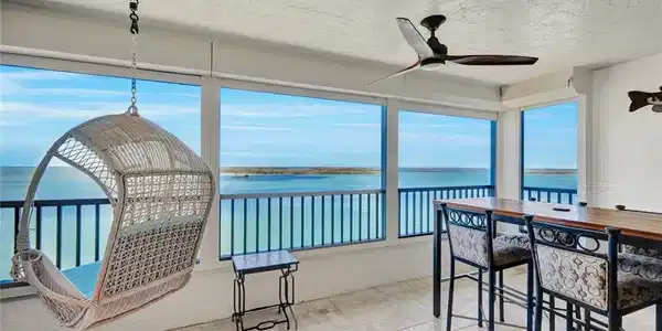 Image 3: Sunroom / solarium with a water view and a textured ceiling