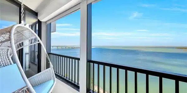 Image 4: Balcony featuring a water view