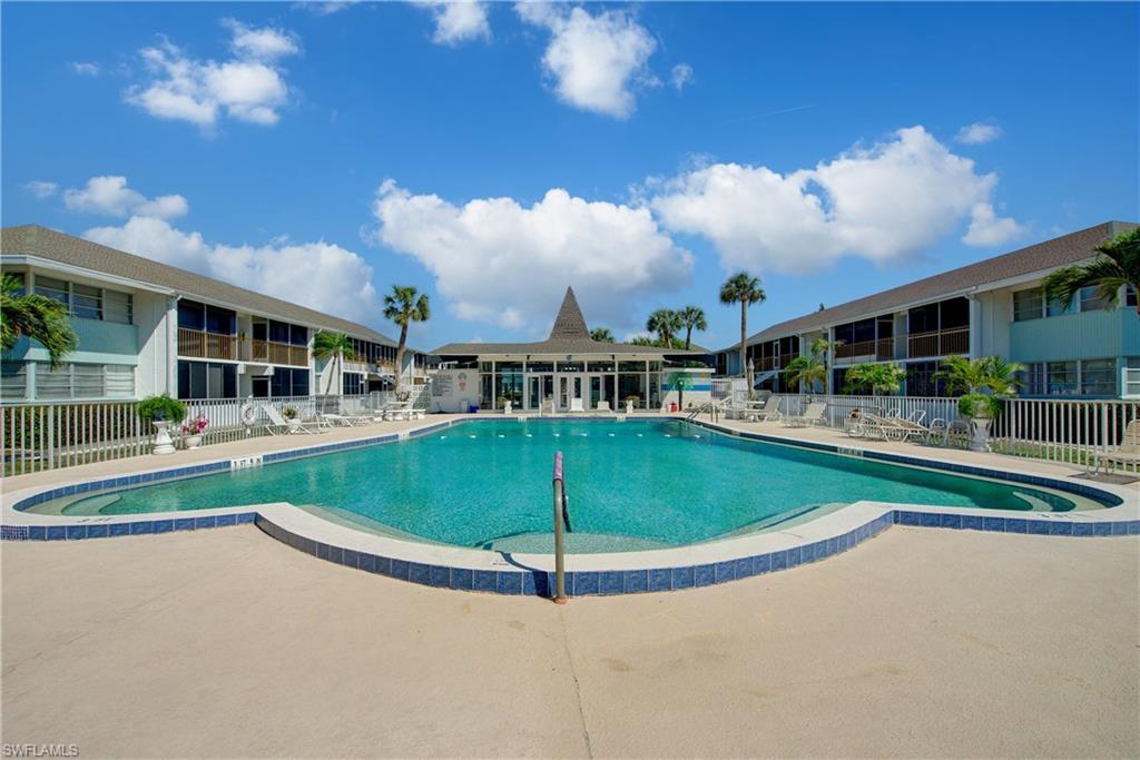 Image 1: Beautiful, heated community pool featuring a patio.
