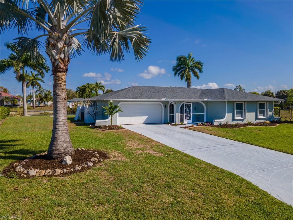 Image 1: Front view of the  home featuring attached garage, concrete driveway and beautiful front yard.
