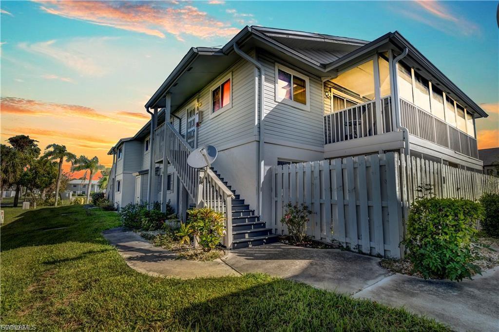 Image 2: Property exterior at dusk featuring a lawn and a balcony