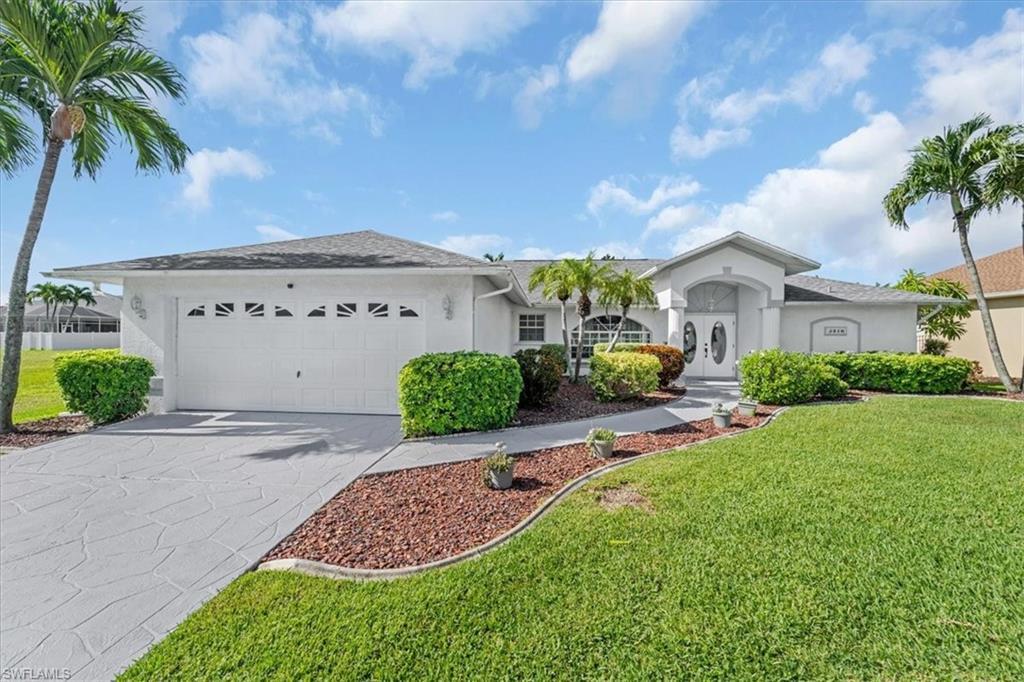 Image 1: Ranch-style home with stucco siding, concrete driveway, an attached garage, and a front lawn