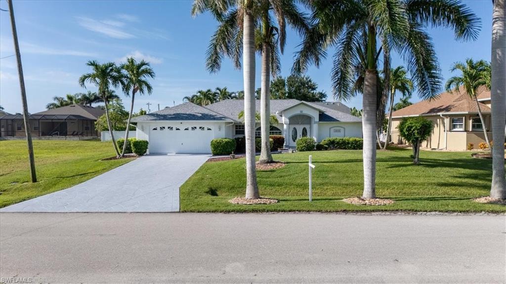 Image 3: Single story home featuring an attached garage, driveway, and a front lawn