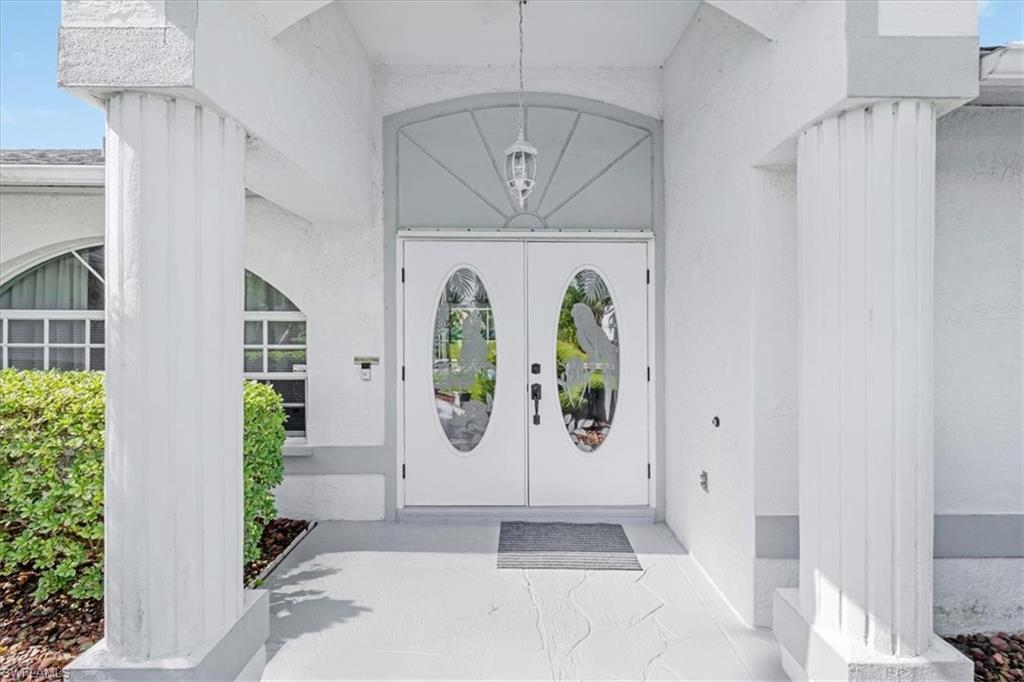 Image 4: View of exterior entry featuring stucco siding
