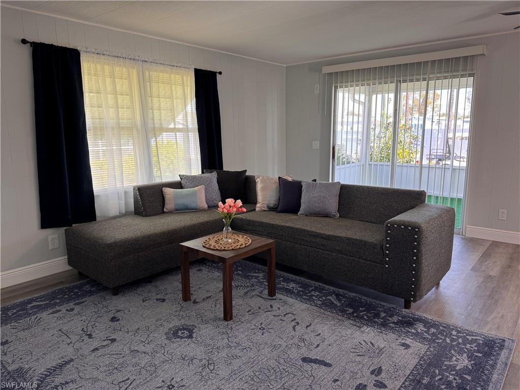 Image 4: Living room with laminate flooring, slider access to front sunroom