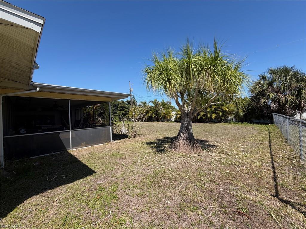 Image 2: View of yard featuring a screened in lanai