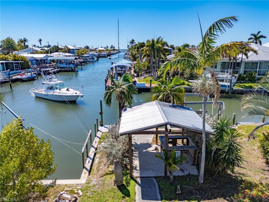 Image 3: View looking south down the canal to the bay. Shared cut-in boat slip and covered bar with metal roof