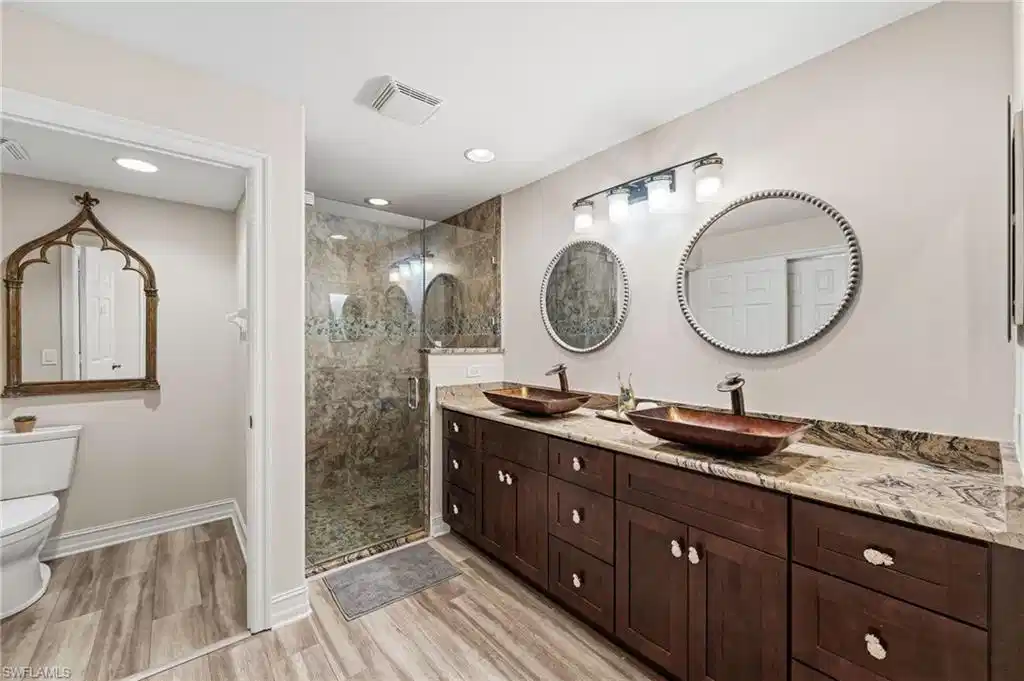 Image 1: The primary ensuite bath has been freshly painted in soft, neutral tones, creating a serene and inviting atmosphere.