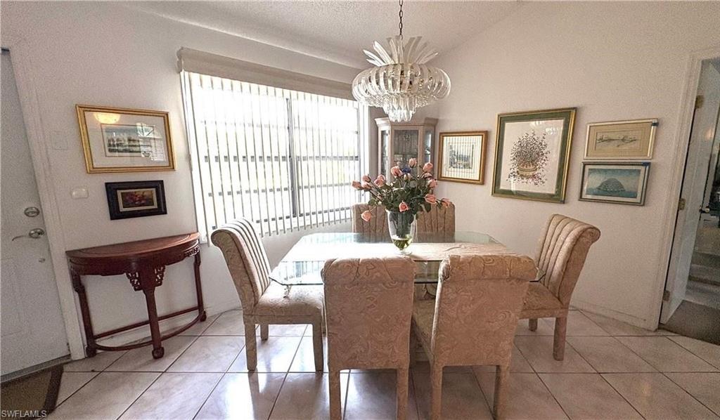 Image 4: Cheerful entryway to the Dining area of this 2nd-floor condo featuring tile flooring & cathedral ceiling!