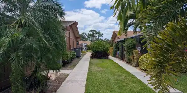 Image 3: Walkway from parking to unit and pool.