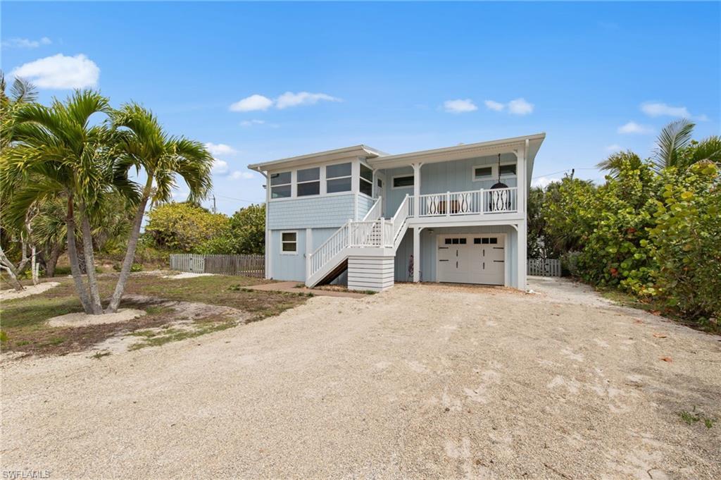 Image 4: Coastal home with driveway and a garage