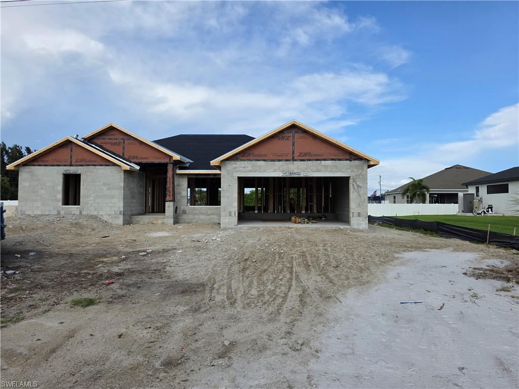 Image 1: New construction featuring concrete block walls, a black shingle roof, and wood frame gable ends